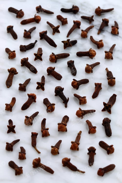 Preview: Beautiful Cloves, Aromatic Flower-Buds, On Carrara Marble Countertop.