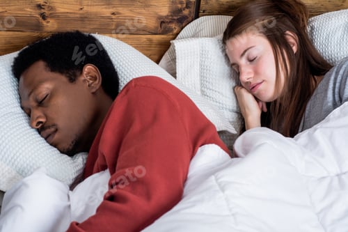 Preview: Close-Up Of Multiracial Couple Sleeping In A Comfortable Bed At Home.