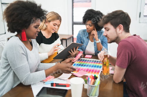 Preview: Young Creative Designers Working In A Project And Discussing New Order Development On Workplace