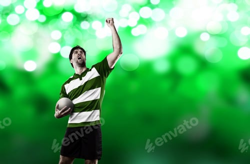 Preview: Rugby Player In A Green Uniform Celebrating On A Green Lights Backgrond.