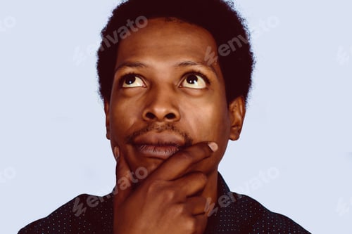 Preview: Portrait Of Afro American Thinking Man With Hand Near Face On Studio.