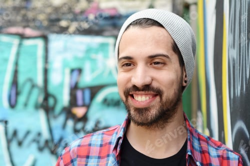 Preview: Portrait Of Young Latin Man Against A Graffiti Wall. Urban Scene.