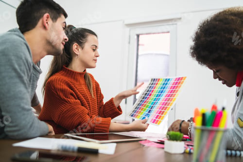 Preview: Young Creative Designers Working In A Project And Discussing New Order Development On Workplace