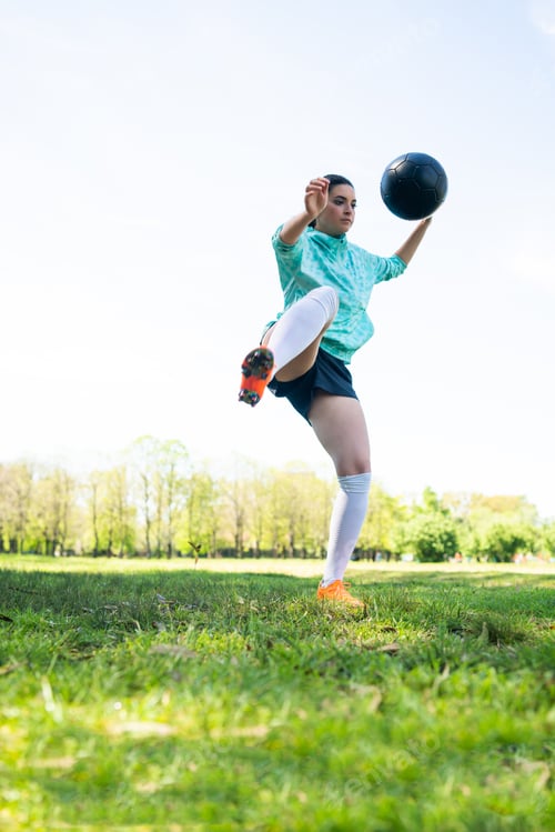 Preview: Portrait Of Young Woman Practicing Soccer Skills And Doing Tricks With The Football Ball. Soccer