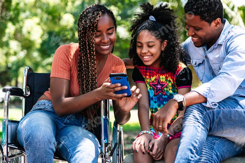 Preview: Woman In A Wheelchair At The Park With Family.