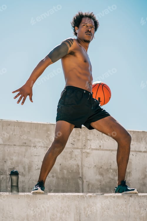 Preview: Afro Athlete Man Playing Basketball Outdoors.