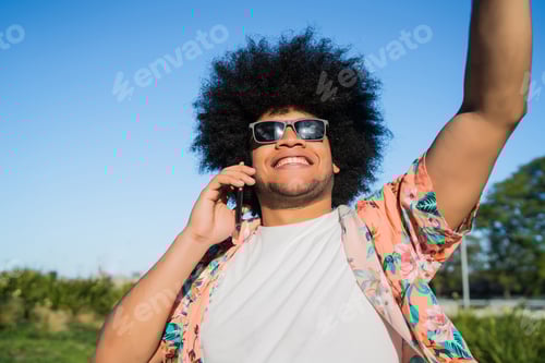 Preview: Latin Man Talking On The Phone Outdoors.