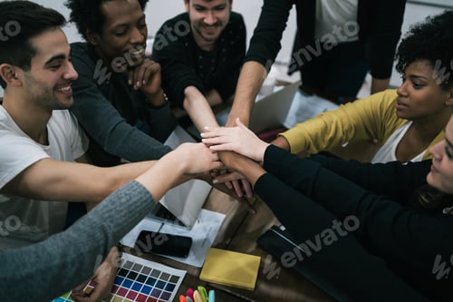 Preview: Team Of Work Of Creative Designers Showing Unity With Their Hand Together During Meeting. Business