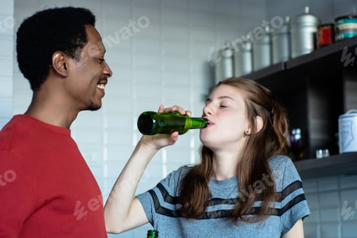 Preview: Young Multi-Ethnic Friends Having Fun With Bottles Of Drink At Home. Friendship Concept