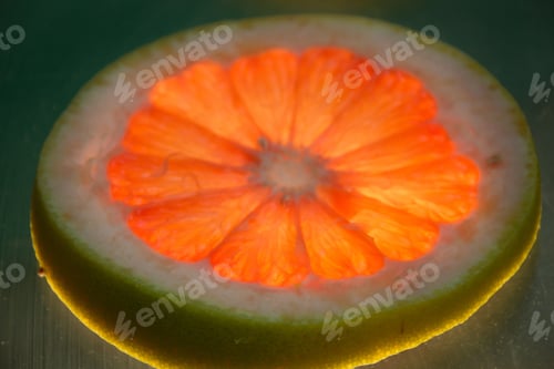 Preview: Photograph Of A Grapefruit Slice On Lighted Glass