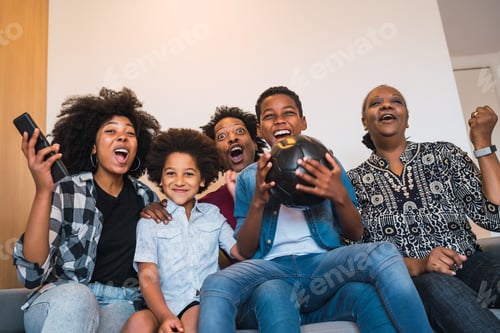 Preview: Happy African American Multi-Generation Family Watching Soccer Match On Television In Living Room