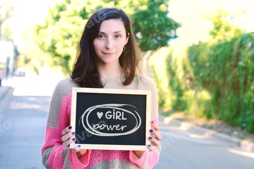 Preview: Woman Holding Girl Power Sign on Street