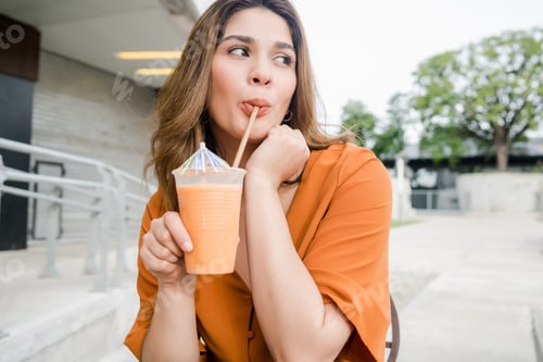 Preview: Woman Drinking Fresh Fruit Juice Outdoors.