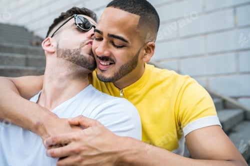 Preview: Portrait Of Happy Gay Couple Spending Time Together While Sitting On Stairs Outdoors. Lgbt And Love