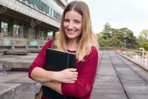 Preview: Portrait Of Young Female Student With Folders And Backpack In College Campus. Education Concept