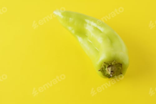 Preview: Close Up View Of Green Hot Chili Peppers On Yellow Background