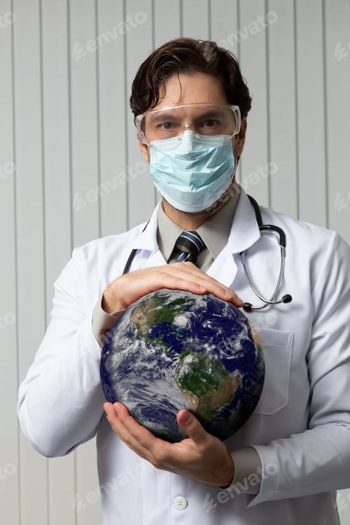 Preview: Male Doctor Wearing A Mask And Goggles With Earth In His Hands, Tired Of Working With Covid-19 On A
