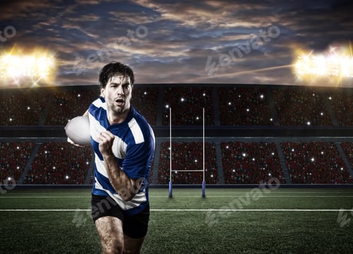 Preview: Rugby Player In A Blue Uniform Running On A Stadium.