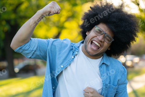 Preview: Young Man Celebrating Victory Outdoors.