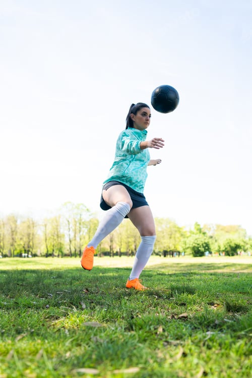 Preview: Young Woman Practicing Soccer Skills With Ball.