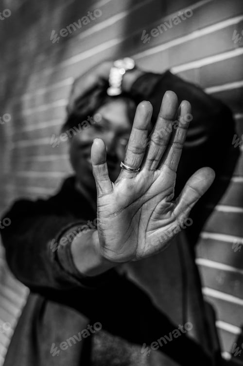 Preview: A Grayscale Shot Of A Smiling Woman Doing A Stop Gesture With A Blurred Background