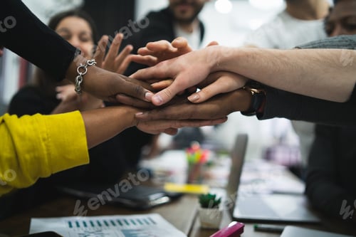 Preview: Team Of Work Of Creative Designers Showing Unity With Their Hand Together During Meeting. Business