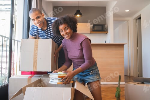 Preview: Portrait Of Happy Latin Couple Unpacking At Their New House At Moving Day. Real Estate Concept.