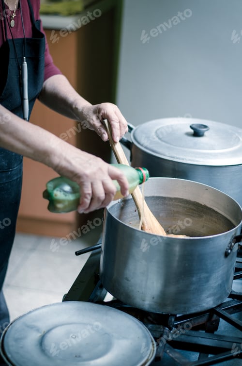 Preview: Hand Of A Woman Adding Ingredients To The Pot Where The Food Is Cooking