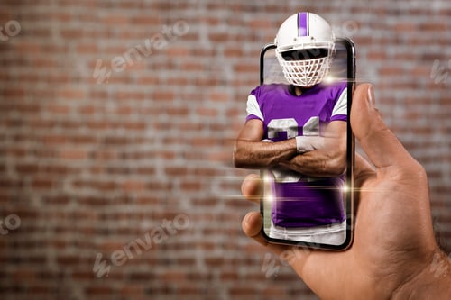 Preview: Football Player With A Purple Uniform Playing And Coming Out Of A Full Screen Phone In Front Of A