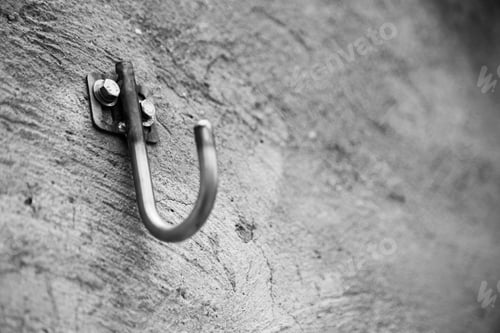 Preview: Metal Hook Bolted Into a Weathered Concrete Wall