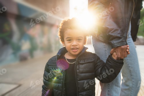 Preview: Portrait Of Cute African American Little Boy Outdoors In The Street Holding His Mother'S Hand.