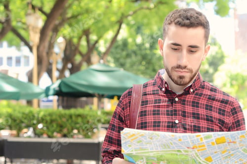 Preview: Portrait Of A Young Handsome Tourist Man Looking At A Map. Tourism Concept. Outdoors.