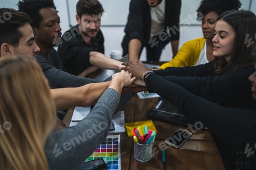 Preview: Team Of Work Of Creative Designers Showing Unity With Their Hand Together During Meeting. Business