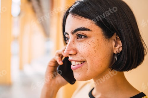 Preview: Close-Up Of Young Latin Woman Talking On The Phone Outdoors In The Street. Urban Concept.