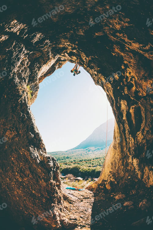 Preview: Rock Climber Climbs Into The Cave. Rock In The Form Of An Arch. The Woman Trains On A Natural
