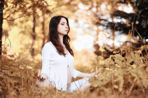 Preview: Pregnant Woman Doing Yoga Exercise In Autumn