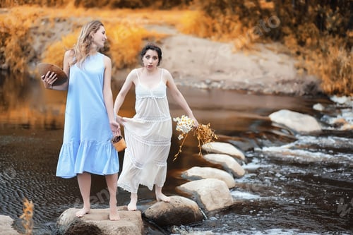 Preview: Beautiful Young Girls In Dresses Cross The Creek In Autumn