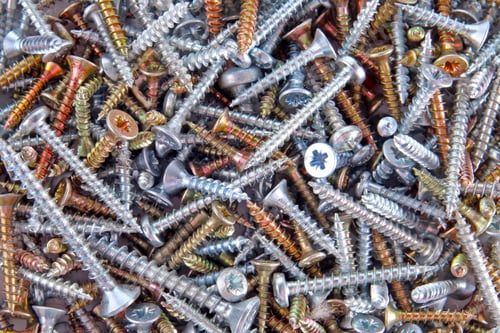 Preview: Box With Silver And Golden Screws Close-Up Background