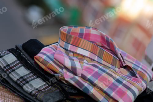 Preview: Folded Shirts and Jeans in Plaid Patterns