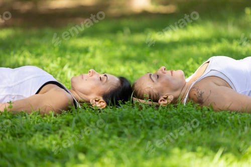 Preview: Women Practicing Yoga In The Savasana Pose Outdoors On Sunny Day, Barueri, São Paulo, Brazil