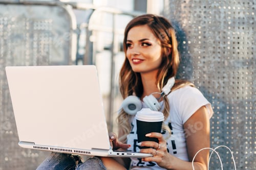 Preview: Young Woman In White T-Shirt With Word "Less" Working For Laptop And Drinking Coffee