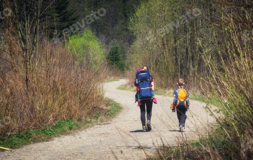 Preview: Mother With Children Walking By The Road In A Forest. Active Family.