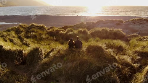 Preview: Young Couple Enjoy The Sunset Over The Ocean – Aerial Drone Footage