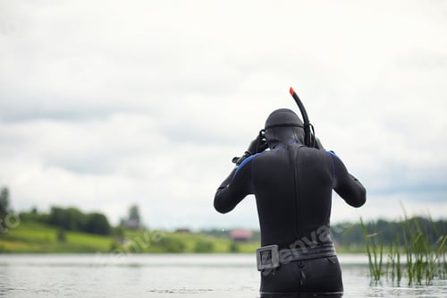 Preview: A Scuba Diver In A Wet Suit Prepares To Immerse In A Pond