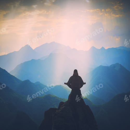 Preview: Silhouette Of Man Meditating In Sitting Yoga Position On The Top Of Mountain Above The Misty