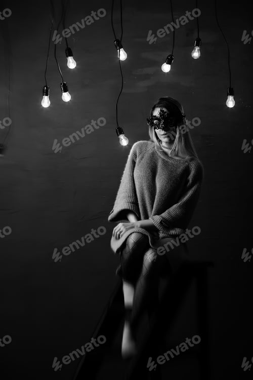 Preview: A Girl With Blond Hair In A Black Mask Poses