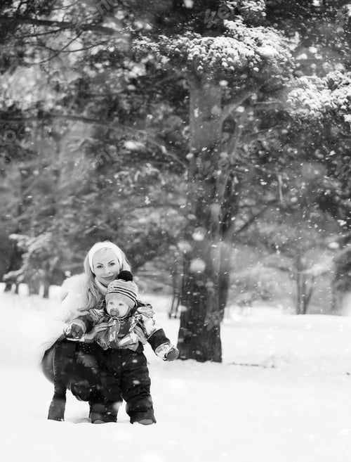 Preview: A Young Mother Walks On A Winter Day With A Baby In Her Arms In The Park