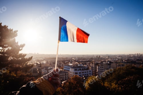 Preview: The Flag Of France On Background Of The View Of Paris From Sacre Coeur Basilica In France In Sunset