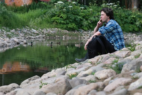 Preview: Man Sit On Stone River