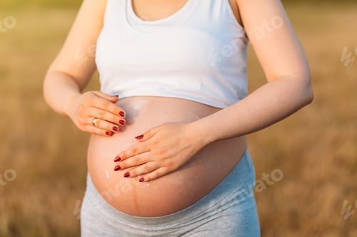 Preview: Beautiful Pregnancy Belly .A Pregnant Woman Rubs Lotion On Big Pregnancy Belly